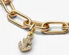 A close-up shot of a gold anchor charm with small diamonds, attached to a gold chain. Podgląd zdjęcia produktu