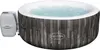 An inflatable hot tub filled with water, with its control unit attached to the side. Produktbild-Vorschau