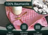 A close-up of a red checkered tea towel with a cup and spoon on it, surrounded by cotton bolls and marketing icons. Produktbild-Vorschau