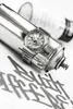 A silver G-Shock watch is placed on a silver spray paint can, with graffiti-style lettering in the foreground. Náhled obrázku produktu