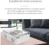 A white CD player with a clear lid sits on a wooden table next to a dark gray sofa in a living room. Produktbild-Vorschau