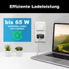 A laptop charger plugged into a wall socket, with a laptop and plants on a desk. Produktbild-Vorschau