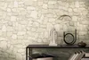 A shelf with decorative items against a stone-patterned wallpaper. Náhľad obrázku produktu