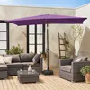 An outdoor patio scene with furniture and a large purple umbrella. Anteprima dell’immagine prodotto