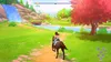 A person riding a horse through a scenic landscape with a waterfall and a large tree. Produktbild-Vorschau