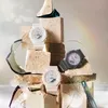 Three Casio G-Shock watches are displayed on stacked stone blocks, with decorative glass shards and a subtle rainbow effect in the background. Anteprima dell’immagine prodotto