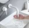 A person is washing their hands under a white wall-mounted faucet in a modern bathroom. Náhľad obrázku produktu