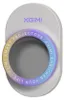 A close-up of a white, oval-shaped device with a circular opening in the center. A colorful, iridescent ring surrounds the opening, with text inscribed on it. Produktbild-Vorschau