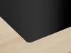 A close-up view of a black induction hob with a wooden countertop. Anteprima dell’immagine prodotto