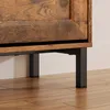 Close-up of the bottom section of a wooden cabinet with black metal legs. Produktbild-Vorschau