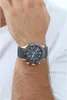 A man's wrist wearing a watch. Voir les images du produit