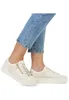 A pair of beige women's sneakers with a platform sole and a side zipper, worn with blue jeans. Náhled obrázku produktu