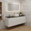 A modern bathroom vanity with a white sink, black countertop, and white drawers, set against a marble-tiled wall and wooden floor. Produktbild-Vorschau