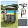 A woman sits at a bar set up in a backyard next to a swimming pool. Náhled obrázku produktu