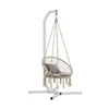 A white metal stand supporting a beige hanging chair with a gray cushion. Podgląd zdjęcia produktu
