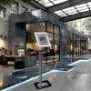 A modern office space with a tablet stand in the foreground. Anteprima dell’immagine prodotto