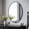 A vanity or dresser with a mirror, flowers, and perfume bottles. Podgląd zdjęcia produktu