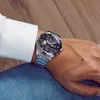 A person wearing a watch on their wrist. Produktbild-Vorschau