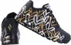 A pair of black SKECHERS Uno Metallic Love women's sneakers with a heart pattern in gold, silver, and white. Produktbild-Vorschau