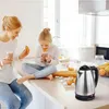 A mother and daughter enjoying drinks in a kitchen. Anteprima dell’immagine prodotto