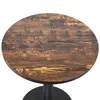 A close-up view of a round wooden table top with a black pedestal base. Produktbild-Vorschau
