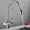 A chrome kitchen faucet with a pull-out spray head and a separate filtered water spout is shown in a kitchen sink setting. Náhled obrázku produktu