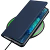 A dark blue flip cover case for a smartphone is shown on a wireless charging pad. Náhled obrázku produktu