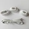 Three white hair removal attachments and a white power cord are laid out on a white background. Podgląd zdjęcia produktu