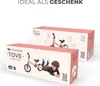 Two boxes of Kinderkraft TOVE balance bikes are shown, one slightly behind the other. The front box features an illustration of a child lying next to the balance bike. The top of the image has text. Produktbild-Vorschau