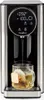 A close-up of a hot beverage dispenser pouring hot water into a glass mug with a tea bag. Anteprima dell’immagine prodotto