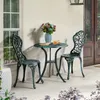 A bistro set for two on a patio, with a vase of flowers on the table. Produktbild-Vorschau