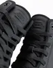 A close-up view of two black high-top sneakers, focusing on the lacing and embossed logo on the tongue. Anteprima dell’immagine prodotto