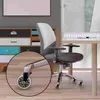 A close-up of an office chair wheel on a wooden floor, with a desk and cabinet in the background. Produktbild-Vorschau