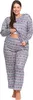 A woman is standing and posing in a pair of pajamas. Produktbild-Vorschau
