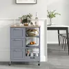 A gray kitchen cart with a wooden top is shown in a room with a dining table and chairs in the background. Voir les images du produit