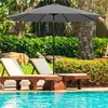 A patio umbrella shades two lounge chairs next to a swimming pool. Produktbild-Vorschau