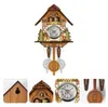 A cuckoo clock with decorative elements, shown against a white background with close-up views of its details. Náhľad obrázku produktu