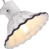 A close-up view of a white ceramic lamp shade with a scalloped edge and a dark trim, showing the light bulb inside. Produktbild-Vorschau