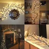 Collage of four images showing illuminated decorative branches in different home settings. Produktbild-Vorschau