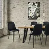 A dining room scene with a wooden table and black velvet chairs, set against a brick wall. Produktbild-Vorschau