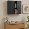 A dark gray metal wall cabinet with books inside is mounted above a wooden dresser. A lamp and a bowl are on the dresser. Voir les images du produit