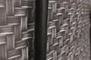 A close-up view of a dark, textured pole against a woven background. Produktbild-Vorschau