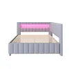 A light gray upholstered bed frame with a pink LED light strip on the headboard, shown from the side. Náhled obrázku produktu