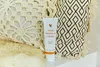 A tube of Forever Aloe Propolis Creme is placed on a shelf with decorative pillows in the background. Anteprima dell’immagine prodotto