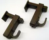 Two brown curtain rod brackets on a white background. Produktbild-Vorschau