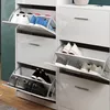 A white shoe cabinet with multiple open compartments displaying various shoes. Anteprima dell’immagine prodotto