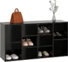 A black shoe cabinet with various shoes and a handbag on top. Náhled obrázku produktu
