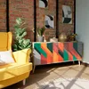 A living room scene with a yellow armchair and a colorful sideboard. Anteprima dell’immagine prodotto