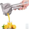 A hand is using a stainless steel citrus juicer to squeeze juice into a glass, with oranges and mint leaves around the glass. Produktbild-Vorschau