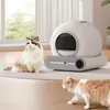Two cats are near an automatic cat litter box in a well-lit room. Anteprima dell’immagine prodotto